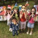 Girls with noisemakers at birthday party outdoors